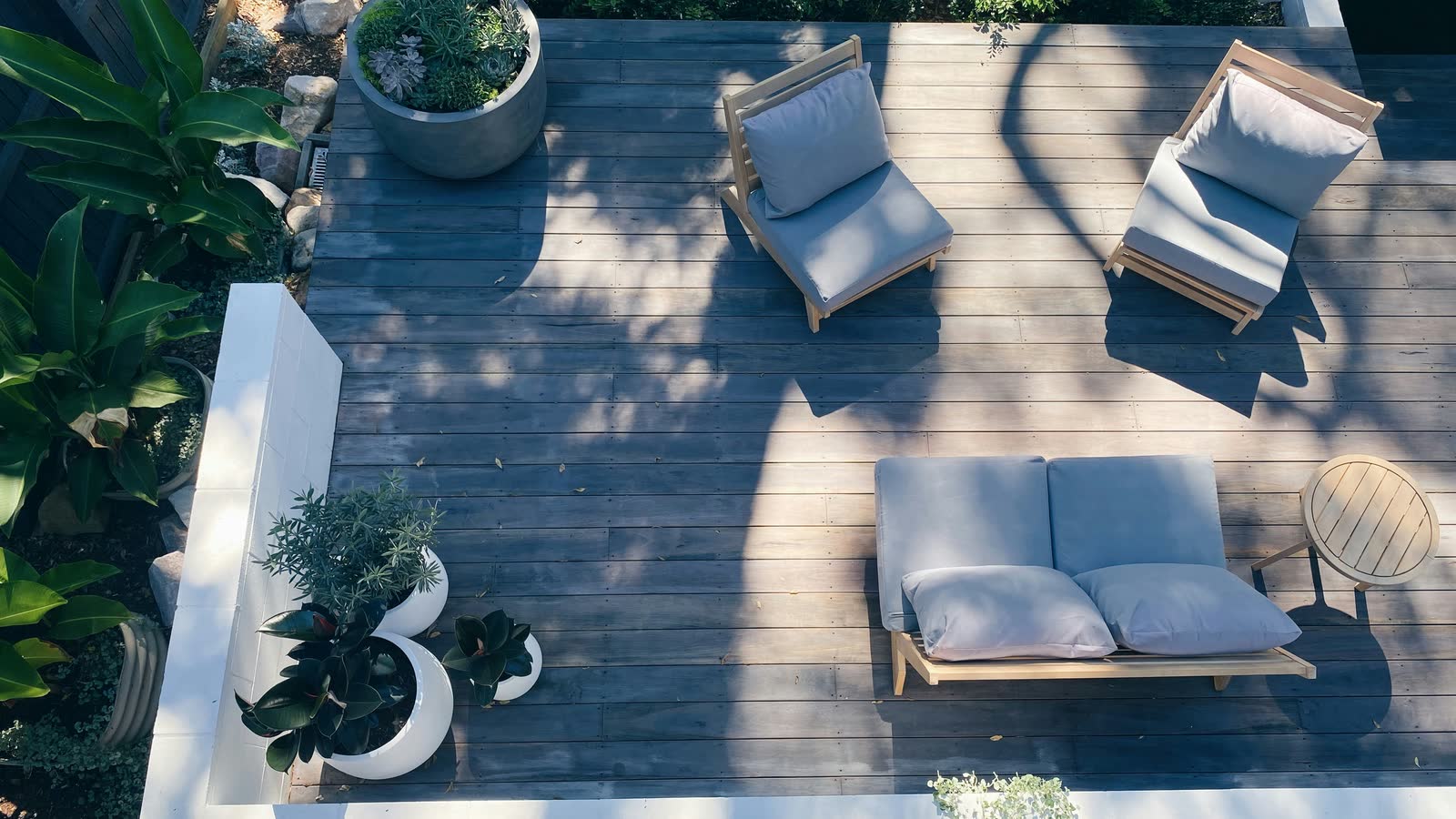 Finished deck with clean lines, planters, and outdoor seating.